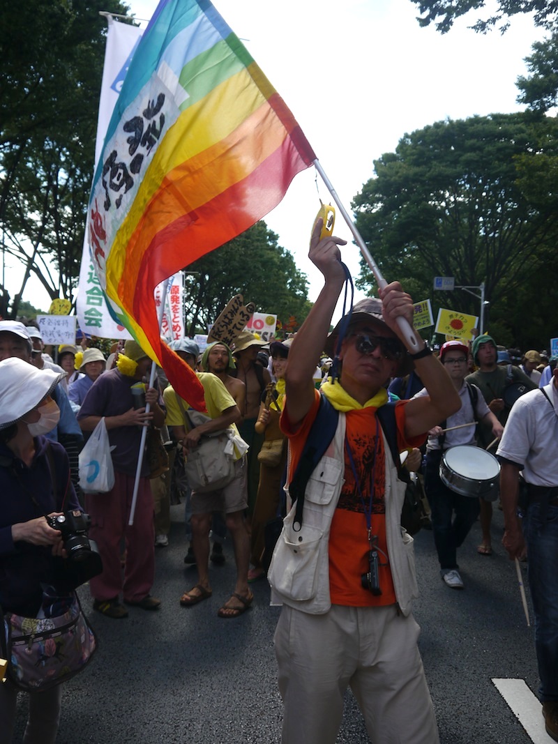 Man waving a rainbow flag